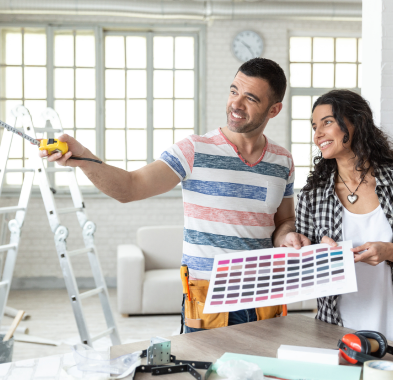 Happy pair choosing paint colors